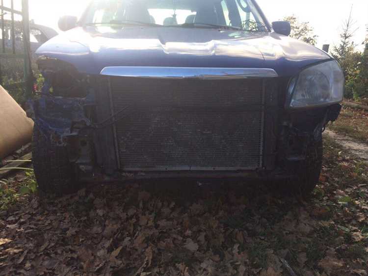 Где находится номер двигателя на mazda tribute